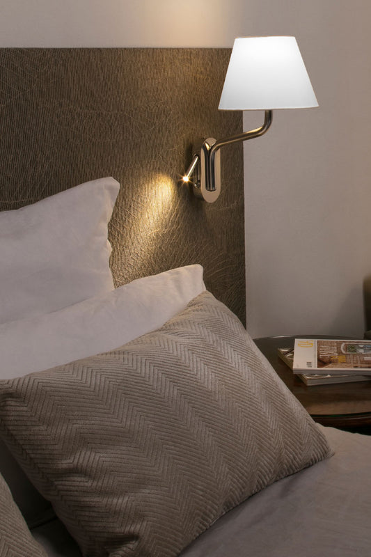 Lámpara de pared ETERNA con lector derecho en cromo y blanca de FARO modelo 24006-10, instalada en ambiente interior de hotel con iluminación superficial y lectura integrada en acero textil