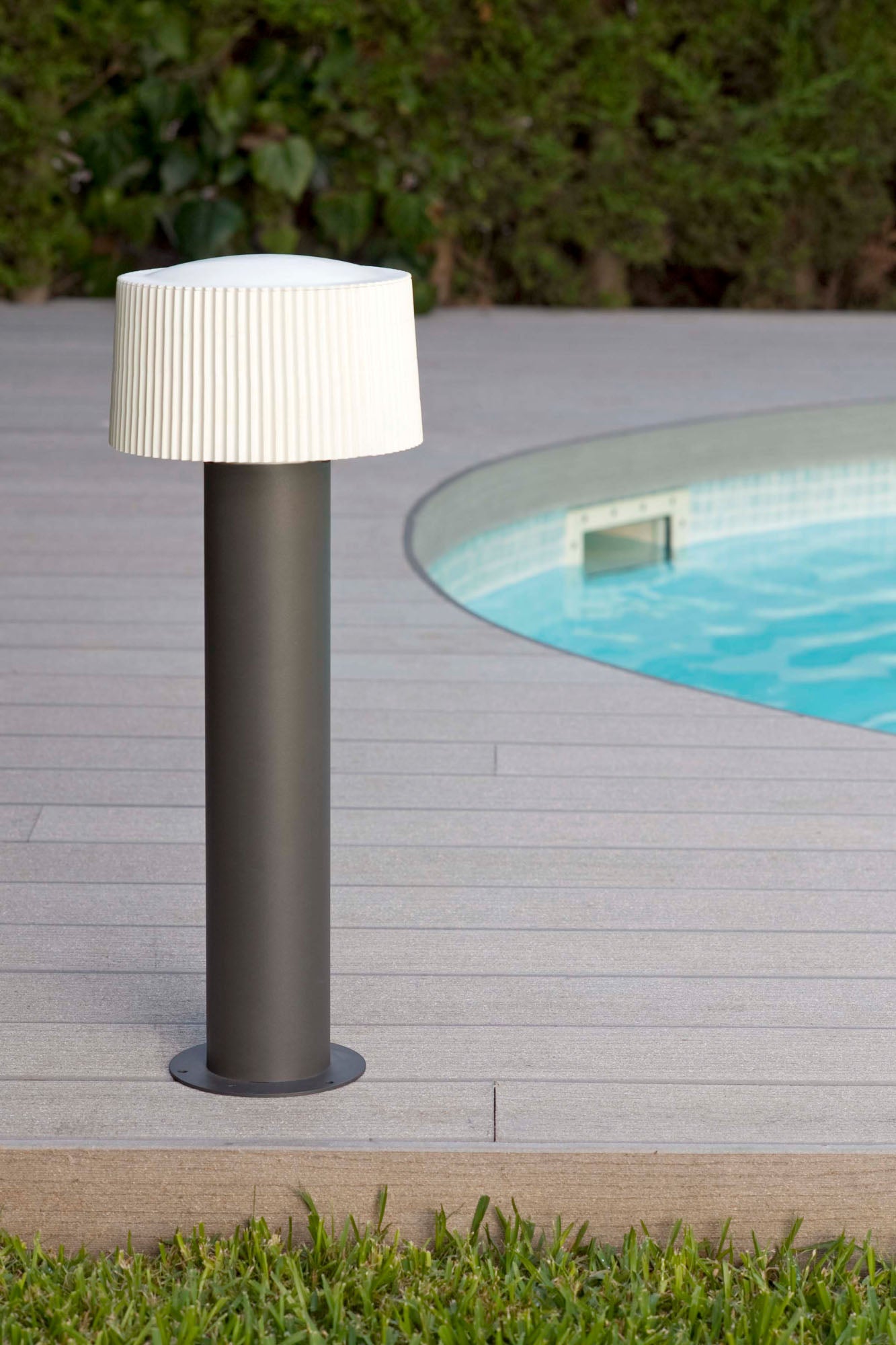 Sobremuro LED exterior MUFFIN 559 en gris oscuro de 61cm, modelo FARO 74434B-04, luminaria de superficie en aluminio y PMMA para iluminación de jardín y terraza, vista ambiental instalada en entorno moderno.