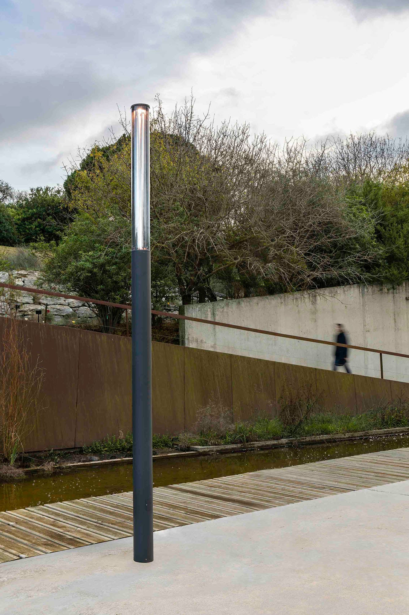 Farola SCREEN 3700 en gris oscuro con LED 2700K instalada en jardín exterior, iluminación resistente IP65 IK10 con control DALI, luminaria superficie para faro ambiente