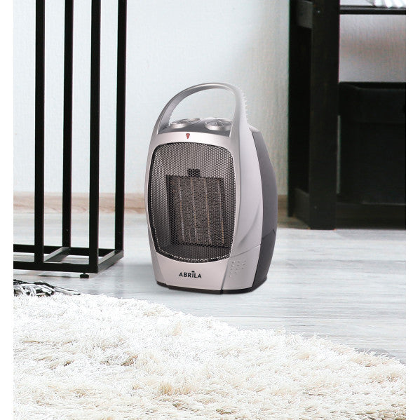 Termoventilador cerámico 1500W negro y plata de Abrila modelo AI2 con protección antivuelco, ideal para calefacción doméstica portátil en interiores