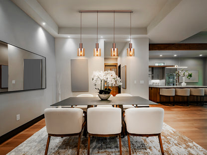 Lámpara de techo Venize 4L cobre-ámbar Schuller en salón industrial, con detalles de cristal y metal, estilo mid-century.