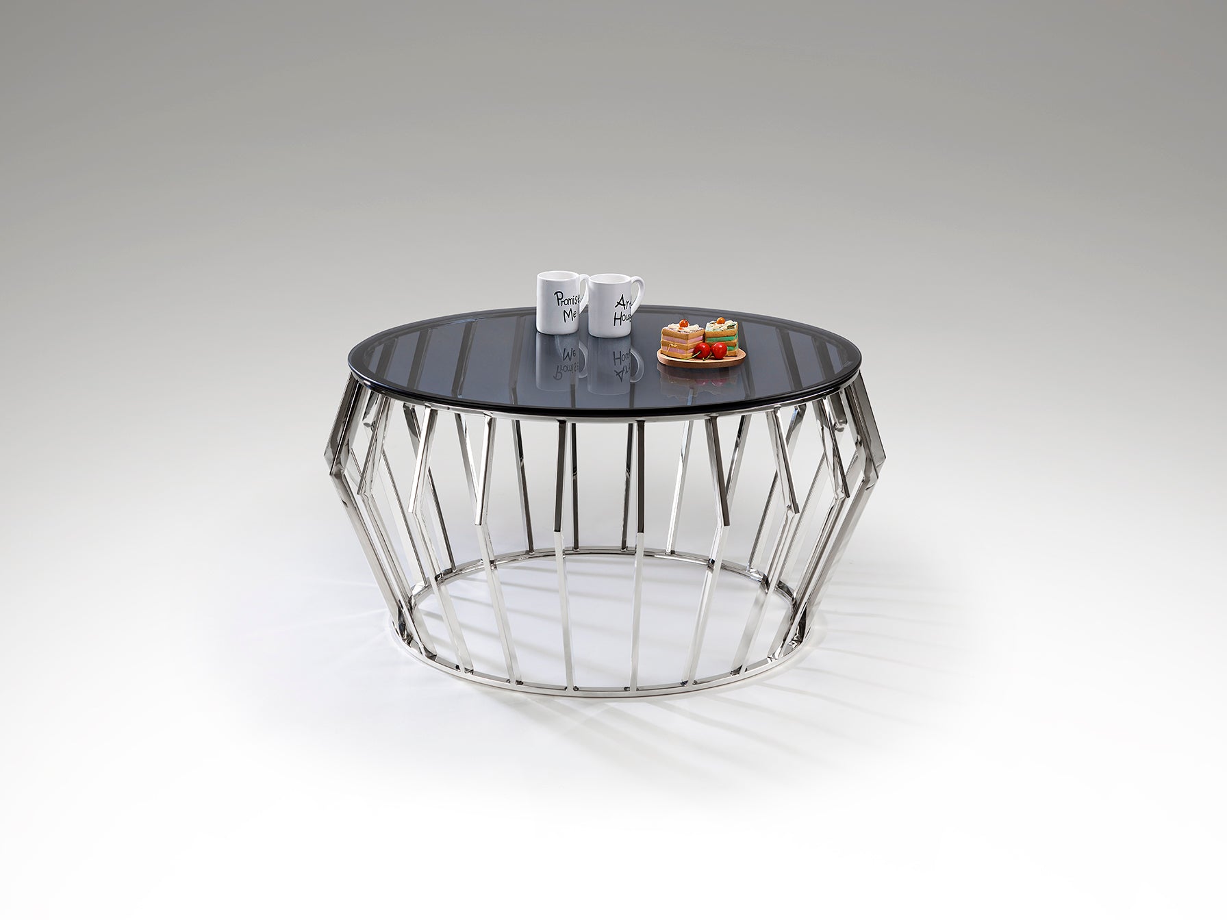 Mesa de centro Ciros pulido brillo de acero inoxidable con tapa de cristal smoke, diseño moderno de Schuller, ideal para salón.