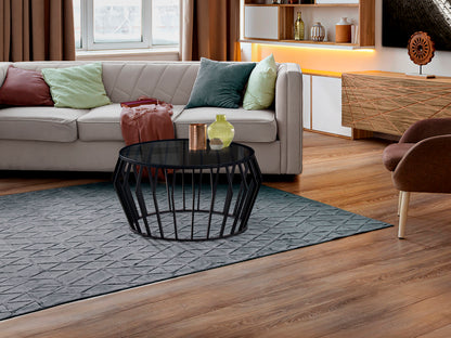 Mesa de centro Ciros negro mate de estilo industrial con tapa de cristal smoke y estructura de metal, ideal para salones modernos. Marca Schuller.