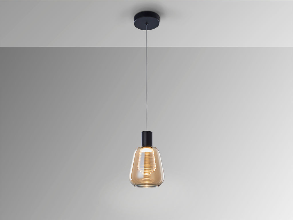 Lámpara colgante Carisa negro y ámbar de Schuller (341017) iluminando un comedor moderno, con diseño en cristal y metal, tecnología LED, regulable en altura, ideal para salón.