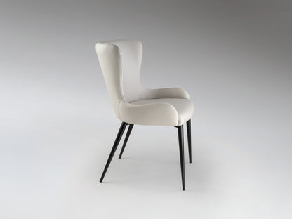 Silla Telma Blanco Hueso Schuller, diseño moderno para comedor o despacho, con estructura de metal negro mate y tapizado textil.
