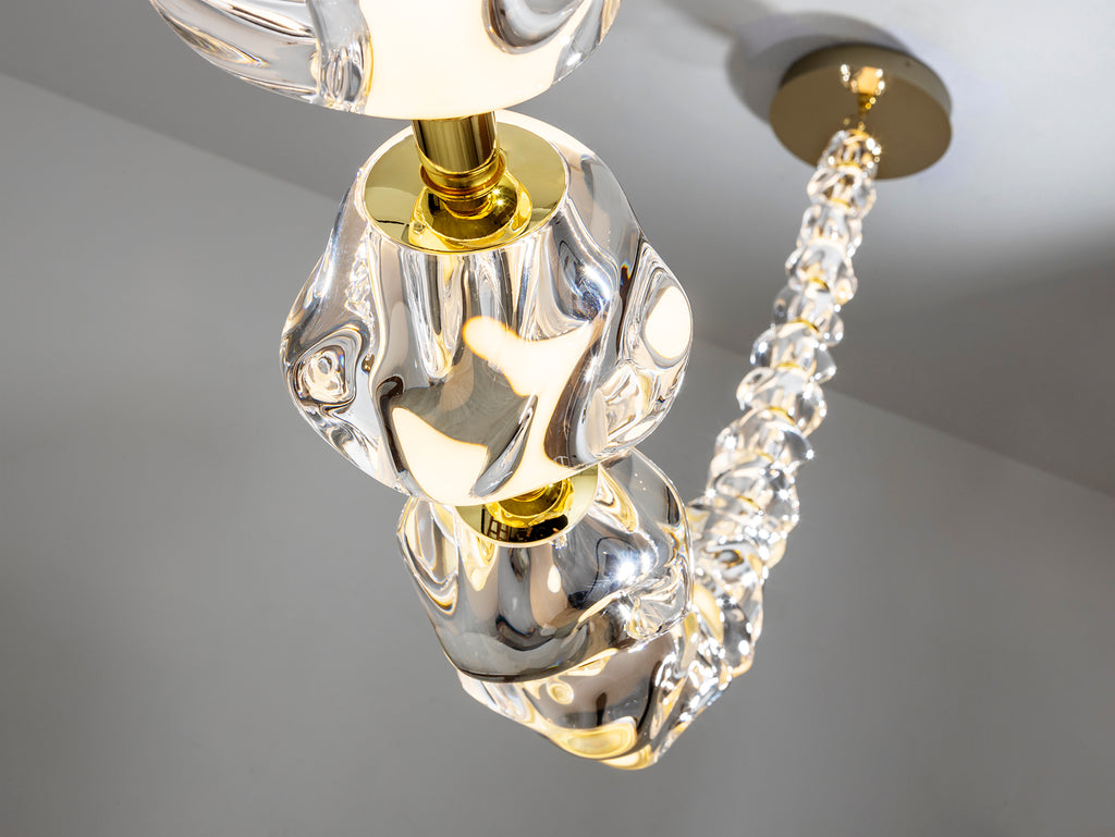 Lámpara Zaria II dorada Schuller - Detalle de la lámpara de metal y 29 tulipas de acrílico transparente (Ref. 448925). Iluminación LED 105W, 3000K, 8704 lúmenes. Incluye driver TRIAC y sistema de regulación.
